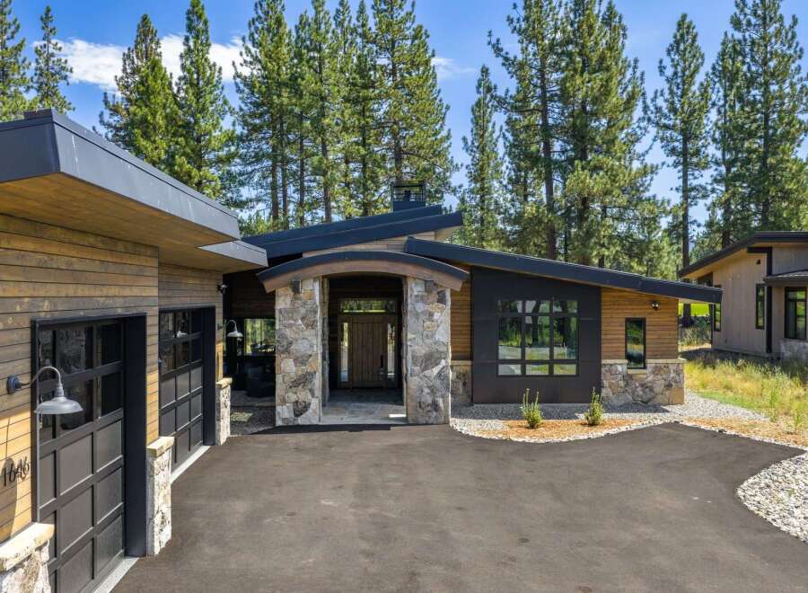 Discover modern mountain living in this stunning home, featuring a striking architectural design with natural wood siding and stone accents.