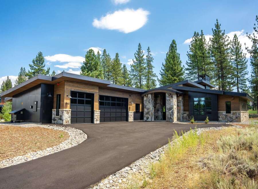 Discover modern luxury in this stunning home featuring a striking architectural design with natural wood and stone accents.