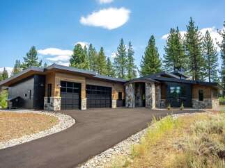 Discover modern luxury in this stunning home featuring a striking architectural design with natural wood and stone accents.