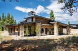 Experience modern mountain living in this stunning home featuring natural wood siding and striking stone accents.