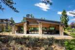 Experience modern mountain living in this stunning home featuring a striking architectural design with natural wood siding and stone accents.