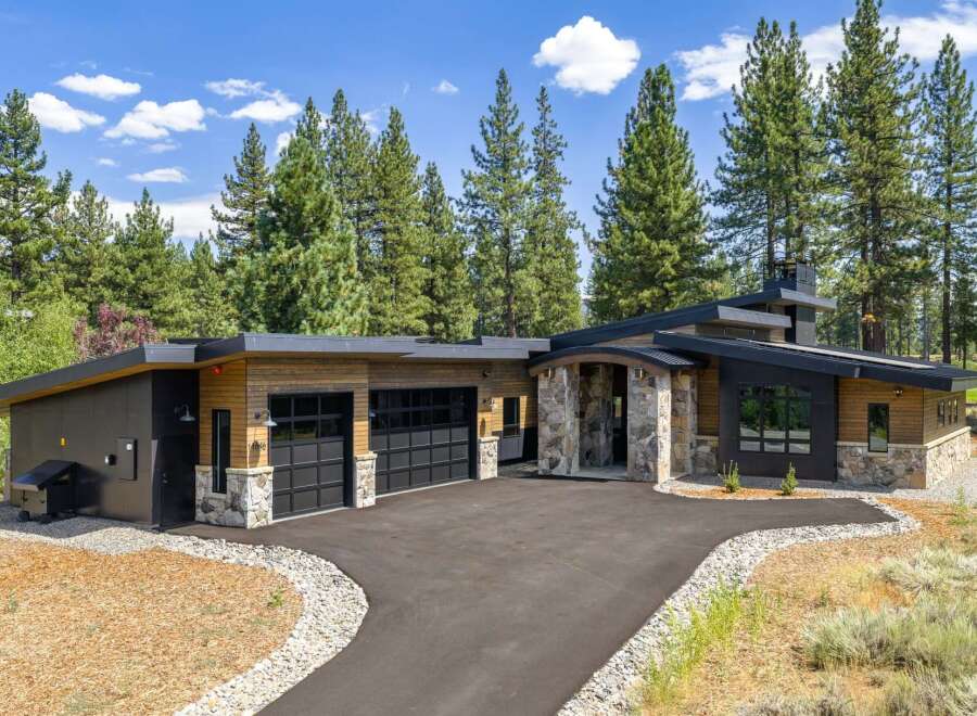 Experience modern mountain living in this stunning home featuring a striking architectural design with natural stone accents and warm wood siding.
