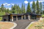 Experience modern mountain living in this stunning home featuring a striking architectural design with natural stone accents and warm wood siding.