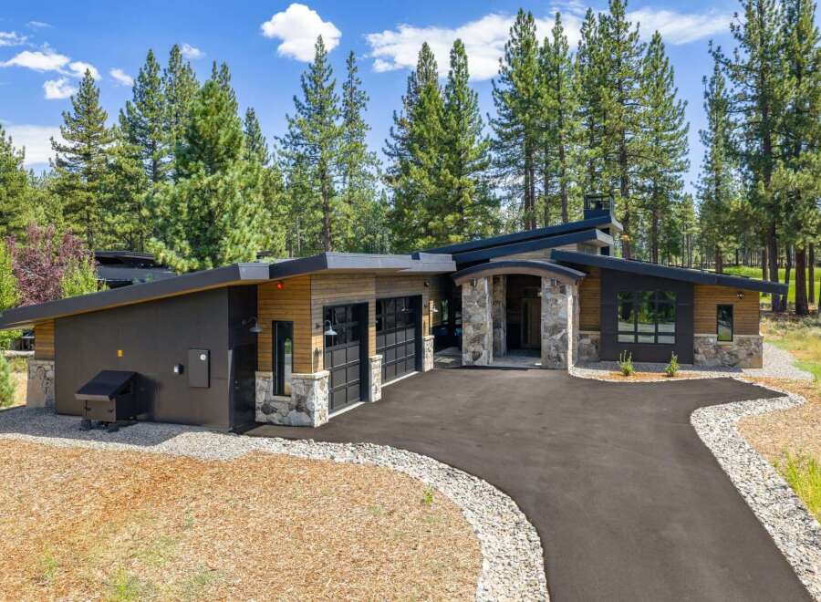 Experience modern luxury in this stunning contemporary home, nestled amongst towering pine trees.