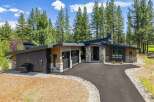 Experience modern luxury in this stunning contemporary home, nestled amongst towering pine trees.