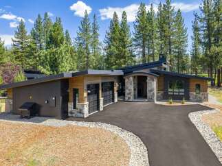 Experience modern luxury in this stunning contemporary home, nestled amongst towering pine trees.