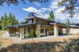 Experience modern mountain living in this stunning architectural home, featuring a striking blend of natural stone and warm wood siding.