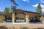 Experience modern mountain living in this stunning home featuring a striking asymmetrical roofline and natural stone accents.