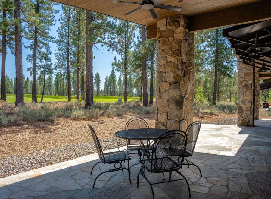 Enjoy outdoor living on this expansive covered patio, perfect for al fresco dining or relaxing with a view.