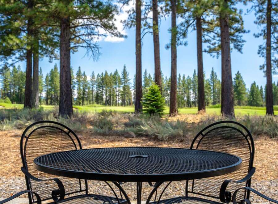 Enjoy your morning coffee or evening drink on this charming patio, complete with a wrought iron table and chairs.