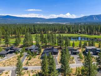Experience luxury living in this modern architectural masterpiece nestled beside a pristine golf course and tranquil lake.