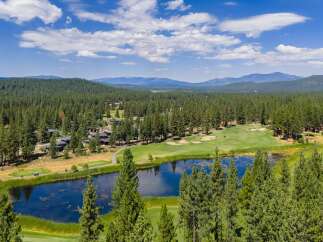 Experience luxury living amidst a stunning golf course and serene lake.