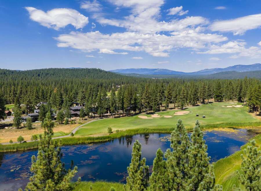 Experience luxury living amidst a stunning golf course setting with this aerial view.