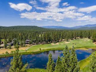 Experience luxury living amidst a stunning golf course setting with this aerial view.