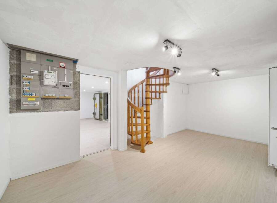 Discover the charm of this unique property featuring a stunning wooden spiral staircase.