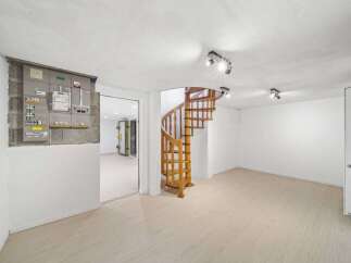 Discover the charm of this unique property featuring a stunning wooden spiral staircase.