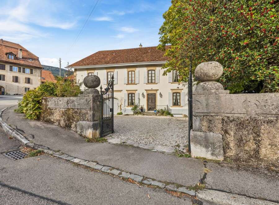 Discover this charming property featuring a classic facade with light-colored walls and a terracotta roof.
