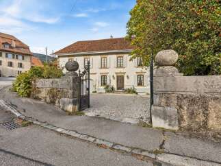 Discover this charming property featuring a classic facade with light-colored walls and a terracotta roof.