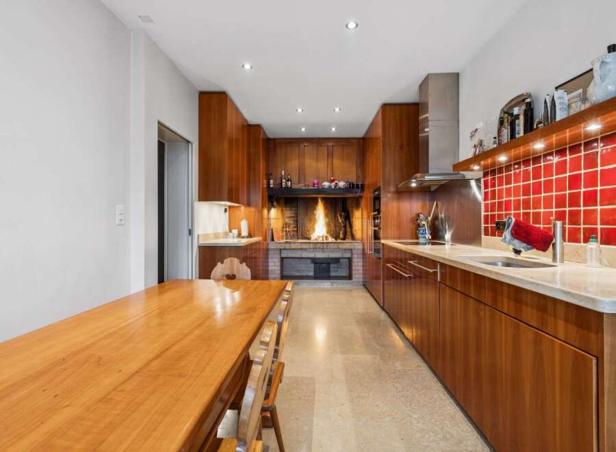 Experience the warmth and charm of this unique kitchen, featuring a stunning fireplace as its centerpiece.