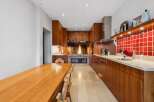 Experience the warmth and charm of this unique kitchen, featuring a stunning fireplace as its centerpiece.