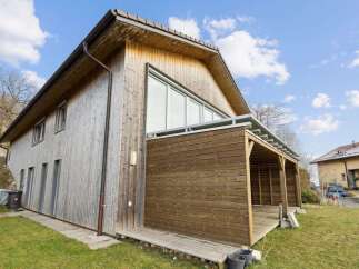 This stunning wooden house offers a unique blend of modern design and natural elements.
