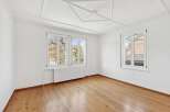 Discover the charm of this bright and airy room, featuring beautiful hardwood floors and ample natural light.