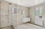 Step into this modern bathroom featuring a spacious walk-in shower with a glass enclosure.