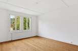 Bright and airy room featuring a large window that offers stunning views of the surrounding nature.