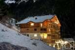 Discover a stunning alpine property nestled in a snowy landscape, perfect for a luxurious retreat.