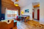 Experience the charm of this stunning property, featuring a cozy living area with a fireplace and a beautiful wooden ceiling.