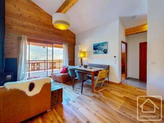 Experience the charm of this stunning property, featuring a cozy living area with a fireplace and a beautiful wooden ceiling.