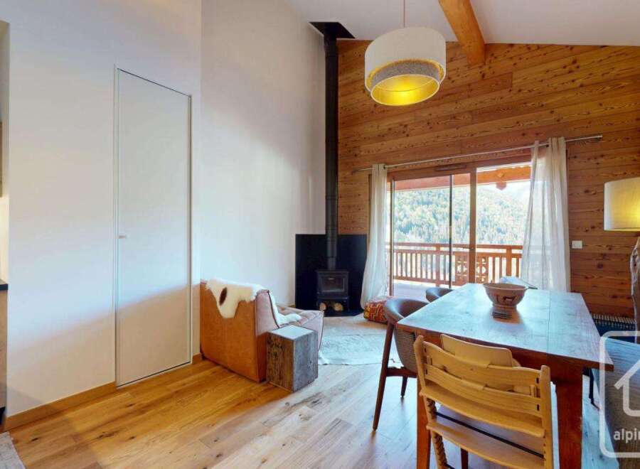 Discover the charm of this stunning property, featuring a cozy living space with a fireplace and wooden accents.
