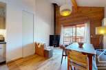 Discover the charm of this stunning property, featuring a cozy living space with a fireplace and wooden accents.