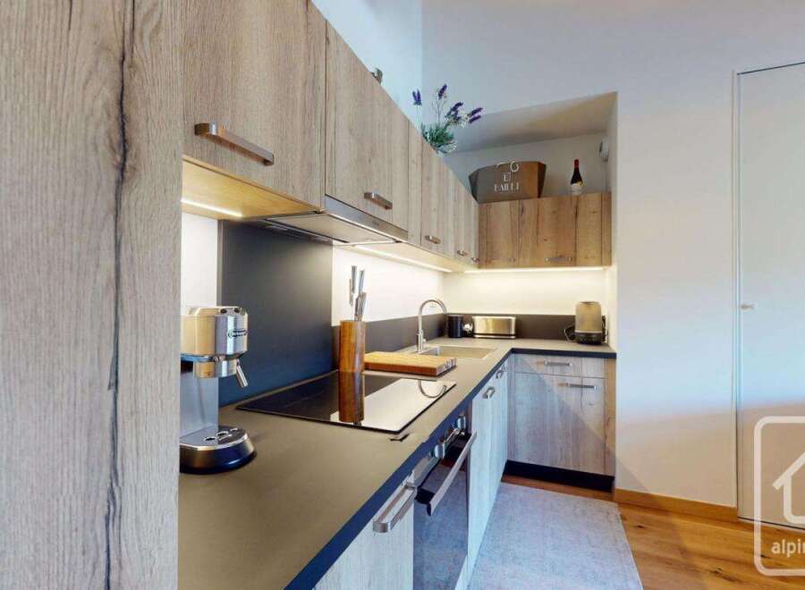 This modern kitchen boasts sleek cabinetry and a functional layout, perfect for culinary enthusiasts.