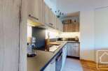 This modern kitchen boasts sleek cabinetry and a functional layout, perfect for culinary enthusiasts.