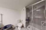 Discover a modern bathroom with a sleek shower enclosure and contemporary fixtures.