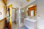 This stunning bathroom features a modern shower, a stylish vanity, and a large mirror, creating a spa-like atmosphere.