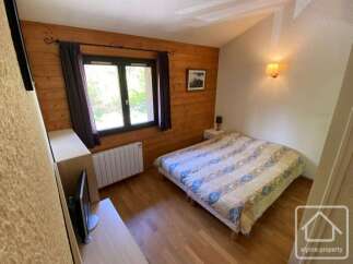 Discover this charming bedroom featuring a cozy bed, perfect for relaxation.