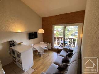 Discover this charming property featuring a cozy living space with a comfortable sofa and a dining area.