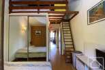 Discover this charming property featuring a cozy bedroom with a loft area, perfect for maximizing space.