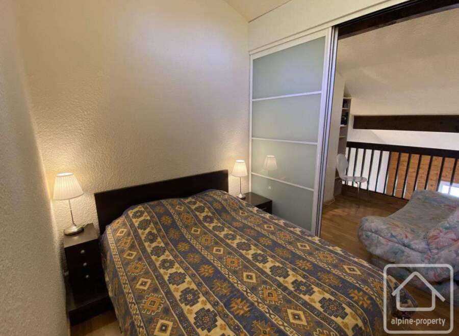 This cozy bedroom features a comfortable bed with a patterned comforter, perfect for a relaxing stay.