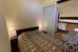 This cozy bedroom features a comfortable bed with a patterned comforter, perfect for a relaxing stay.