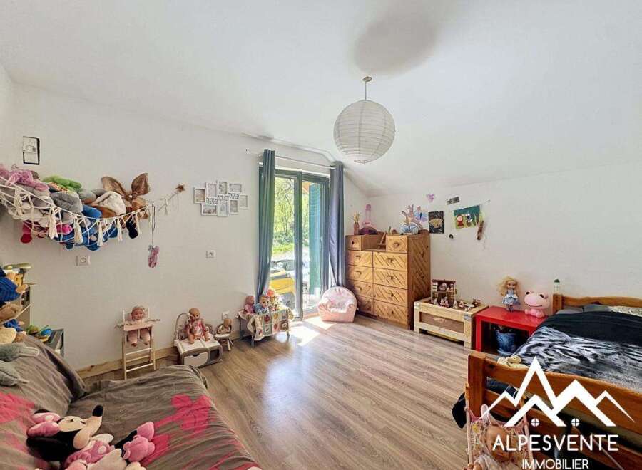 Discover a charming children's room filled with natural light and playful decor.