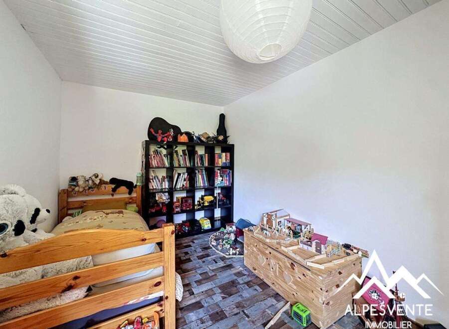This charming bedroom features a cozy bunk bed, perfect for kids or guests.