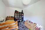 This charming bedroom features a cozy bunk bed, perfect for kids or guests.