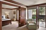 Step into luxury with this beautifully designed bedroom, featuring rich wood accents and a cozy ambiance.