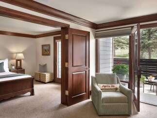 Step into luxury with this beautifully designed bedroom, featuring rich wood accents and a cozy ambiance.