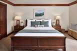 This inviting bedroom features a cozy ambiance with its warm color palette and elegant furnishings.