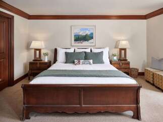 This inviting bedroom features a cozy ambiance with its warm color palette and elegant furnishings.