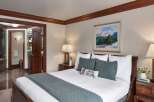 Step into luxury with this beautifully appointed bedroom, featuring a cozy king-sized bed and elegant decor.